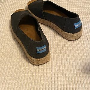 Tom’s black espadrilles